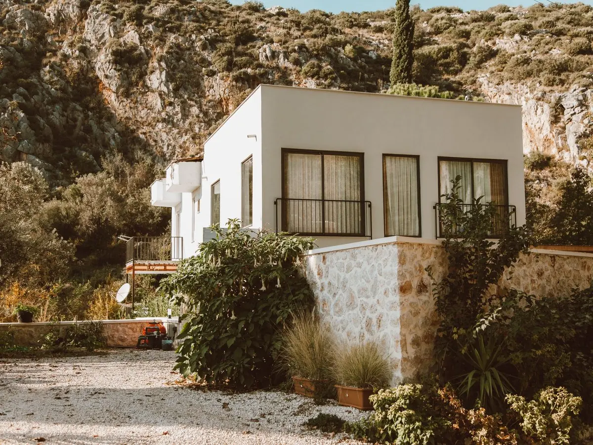 Casa blanca entre rocas y vegetación serrana